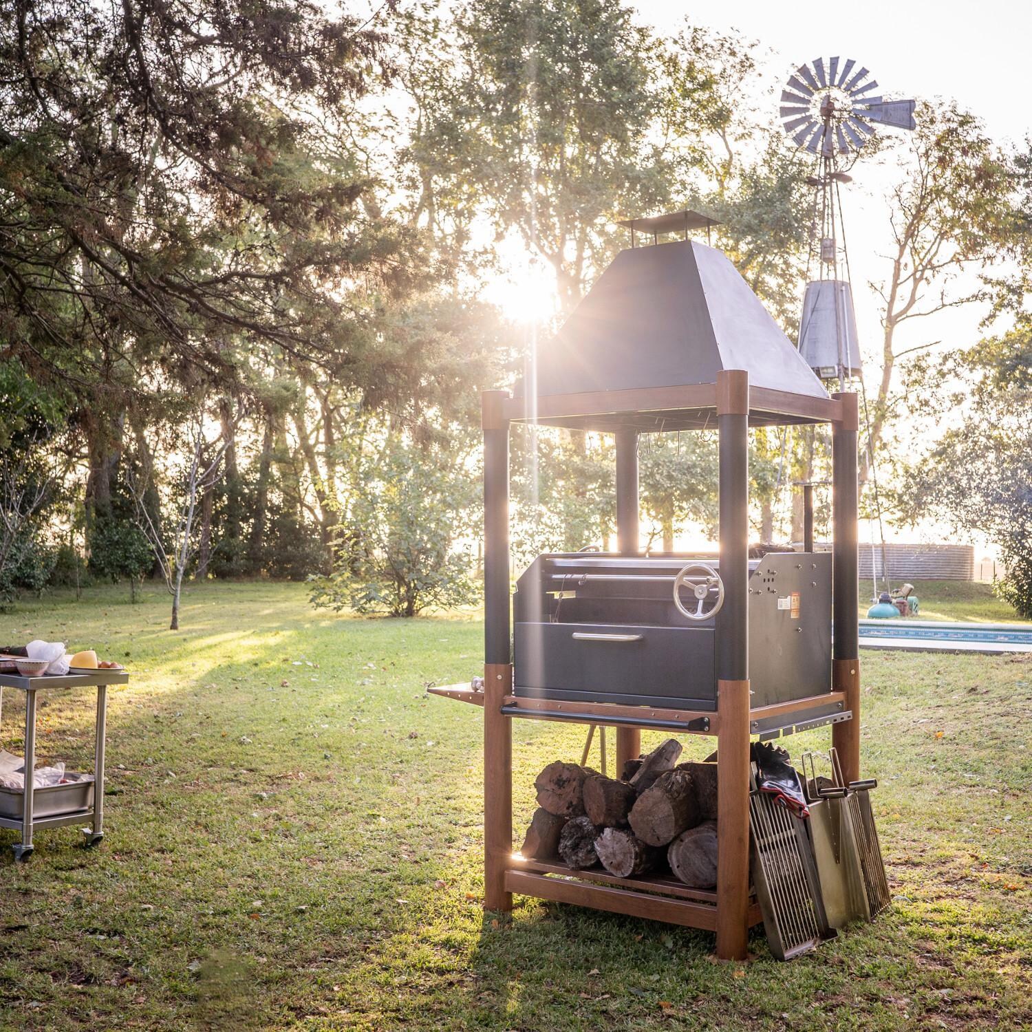Tagwood BBQ02SI BBQ Beast Argentine Wood Fire & Charcoal Grill - Shown in Yard thumbnail