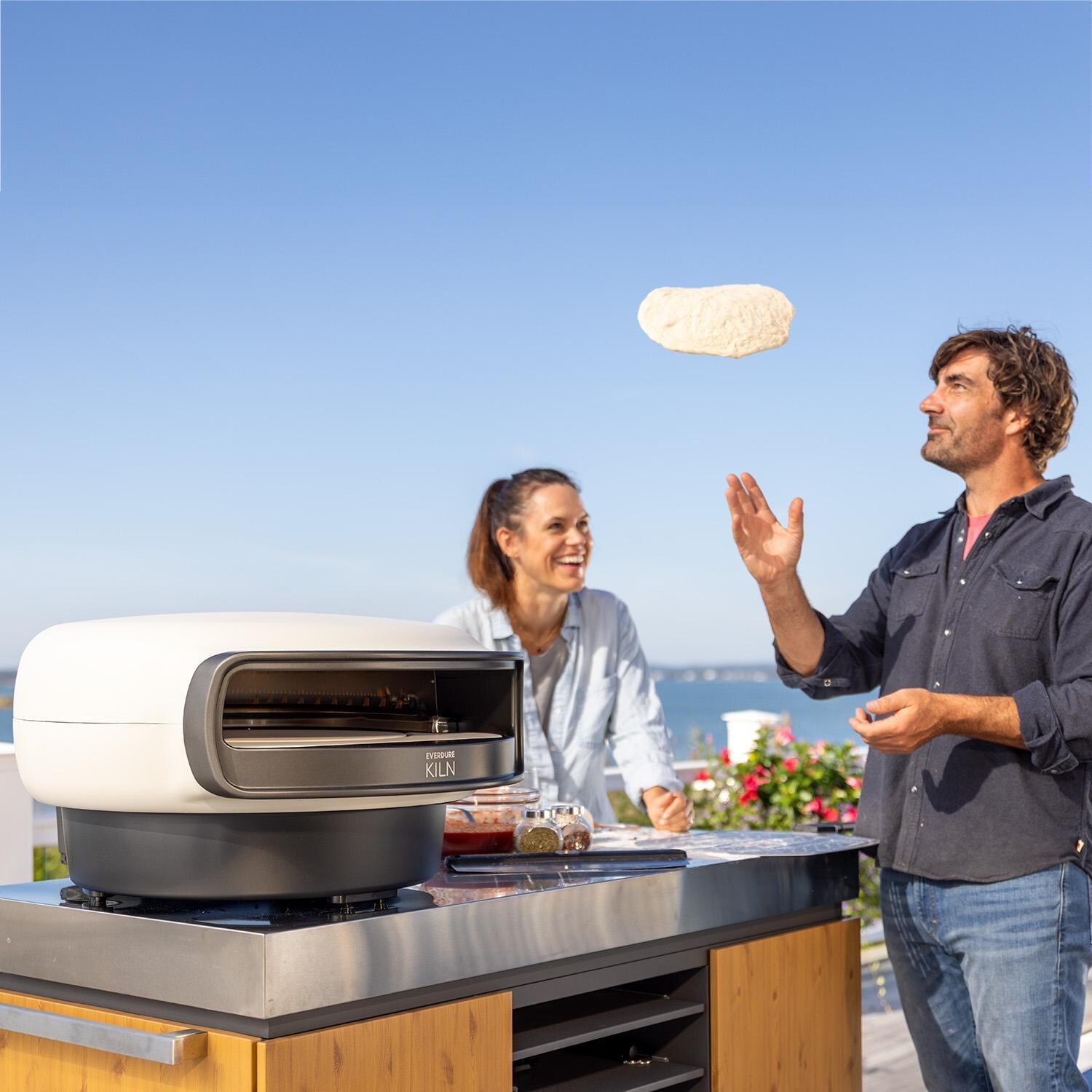 Everdure EKILN2SUSNG Kiln 2 Burner Pizza Oven - Stone - Tossing Dough - Lifestyle thumbnail