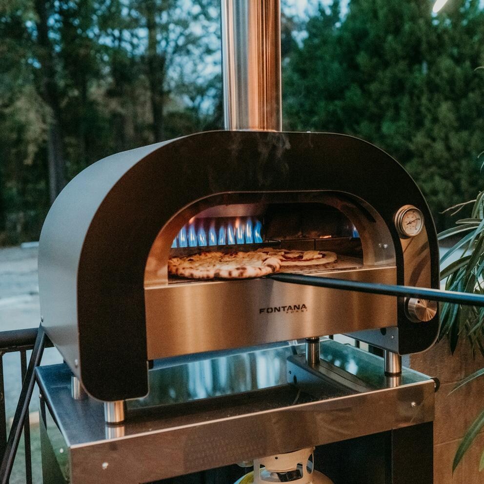 Fontana Forni FFMAES60 Fontana Forni Maestro 60 Gas Fired Pizza Oven - FFMAES60 - Taking out Pizza - Lifestyle thumbnail
