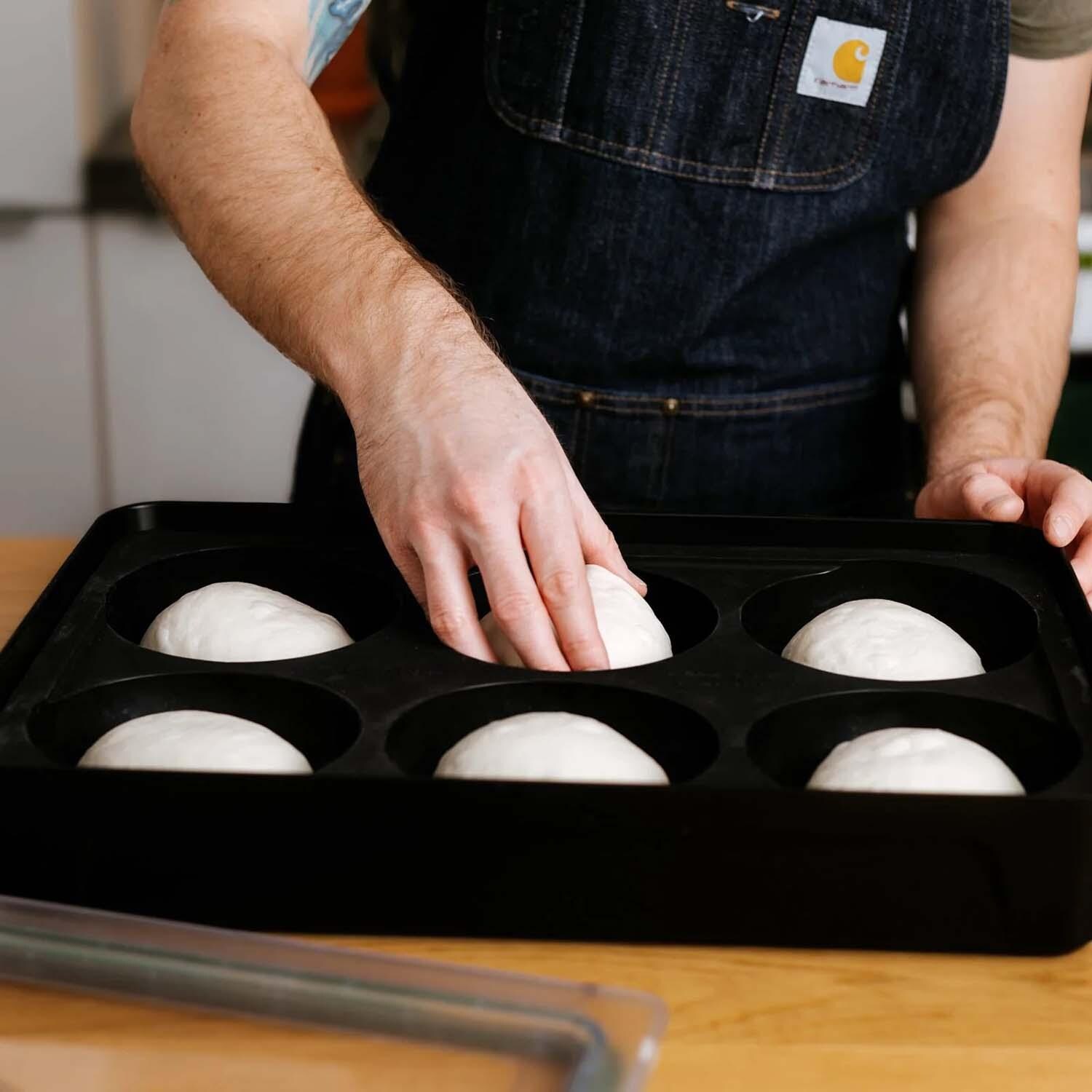 Gozney AD1647 Dough Tray - Putting Dough in Tray - Lifestyle thumbnail