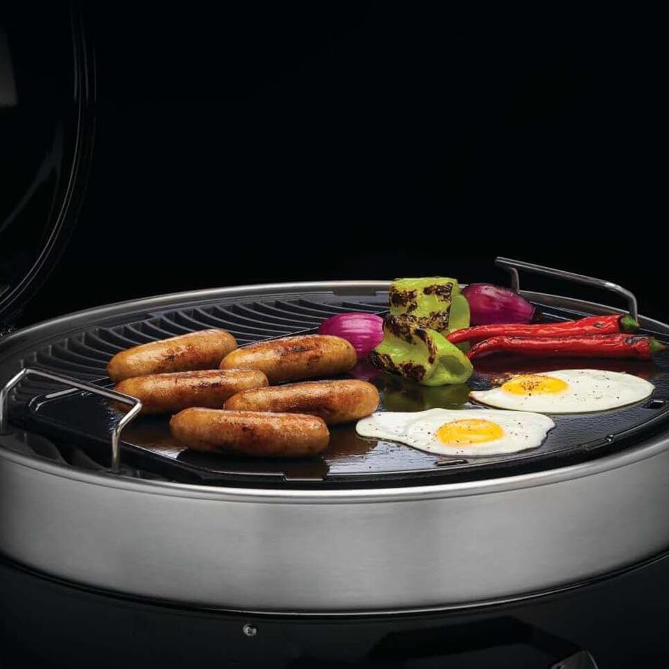 Napoleon 56083 Cast Iron Reversible Griddle for 22 inch Charcoal Grills - In Use - White Background thumbnail