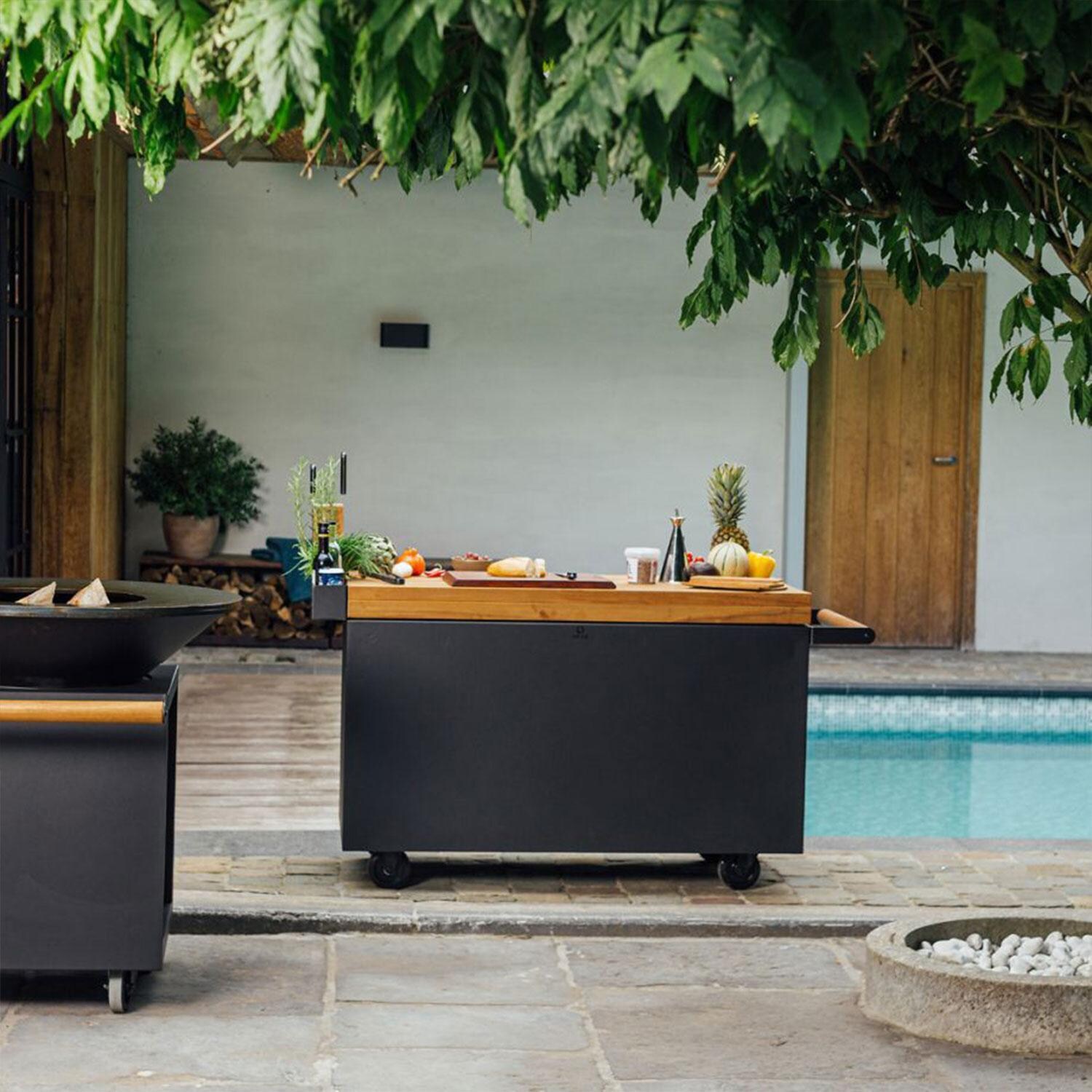 OFYR MP-B-135-PRO-TW Mise en Place Black 135 PRO Teak Wood 65 Inch Food Prep Station - By The Pool - Rear View - Lifestyle thumbnail