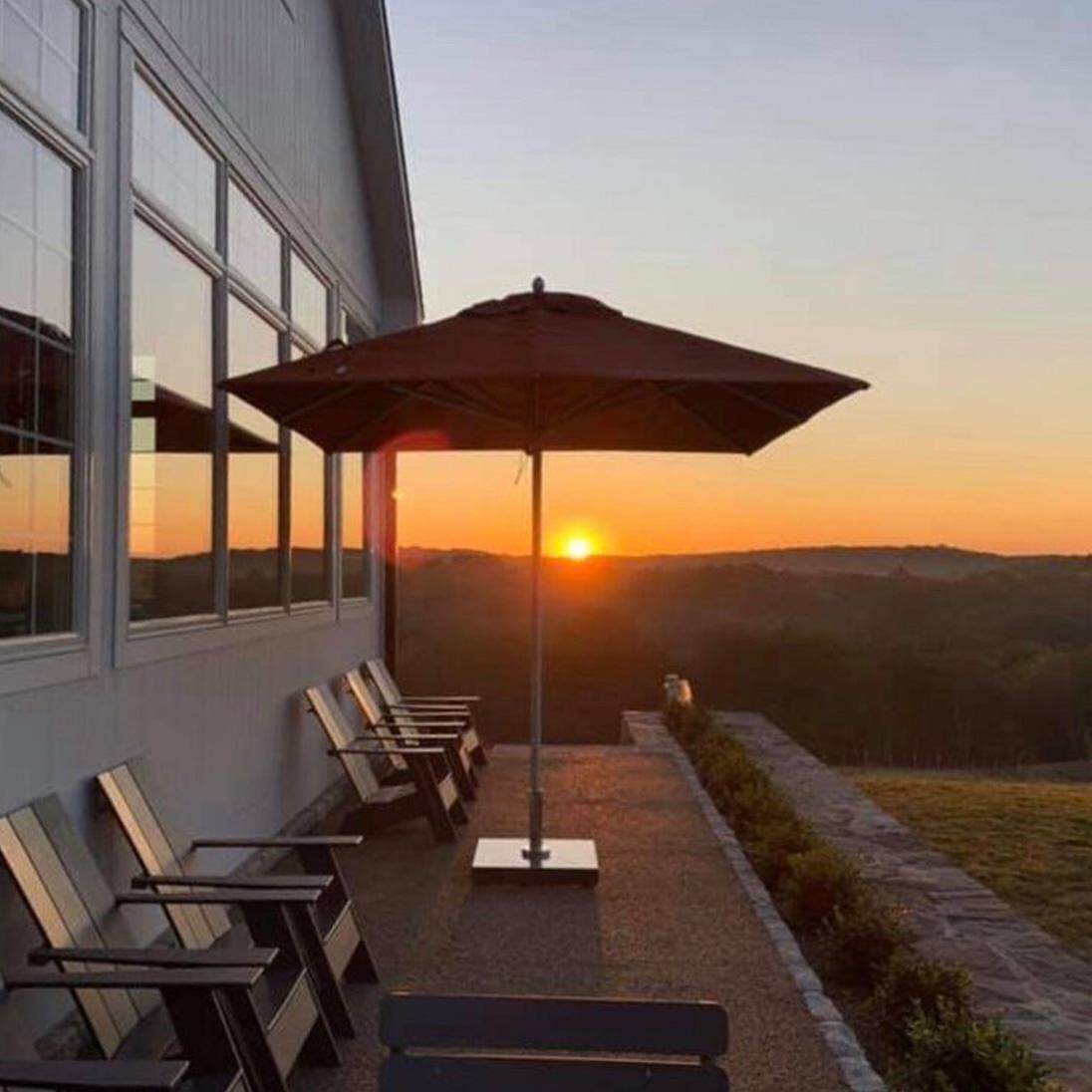 Bambrella 9 Ft. Hexagonal Aluminum Santa Ana Market Umbrella Set w/ 110lb Freestanding Base in Ocean Blue - At Sunset - Lifestyle thumbnail