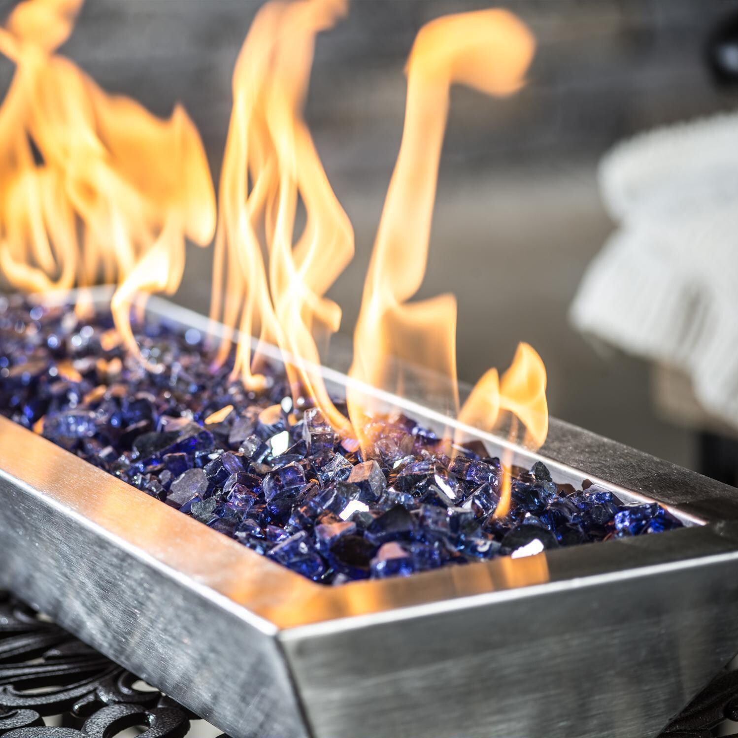 BBQGuys Signature Series Westfalen 18-Inch Table-Top Propane Fire Pit - Stainless Steel - In Use - Shown with 1/2 inch Blue Jay Reflective Fire Glass (Sold Separately) thumbnail