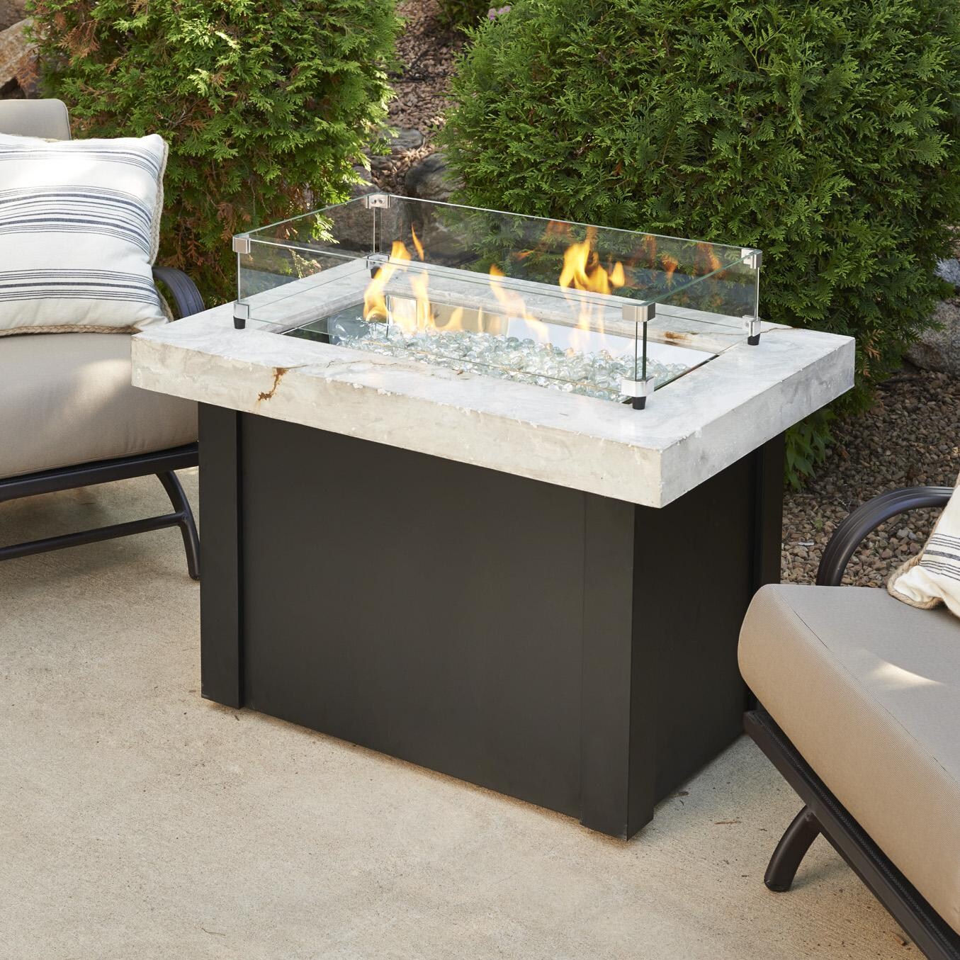 The Outdoor GreatRoom Company Providence Rectangular Gas Fire Pit Table - Lifestyle - Glass wind guard pictured is optional accessory thumbnail