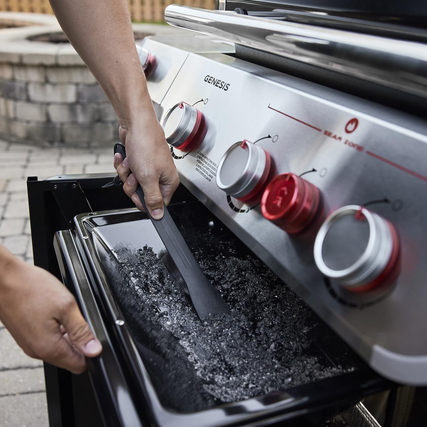 Weber 1500368 GENESIS E-415 Natural Gas Grill in Black - Cleaning Out Grease Management System - Lifestyle