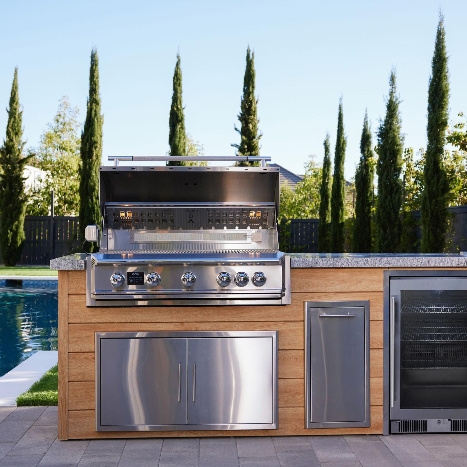 BBQGuys Signature 12 Ft Grill Island w/ 40 Inch Propane Blaze Premium LTE Pro Grill & Griddle, Beverage Center, Narrow Trash Bin & Door & Drawer | Sun Bleached Oak w/ White Granite - Left Side - Lifestyle thumbnail