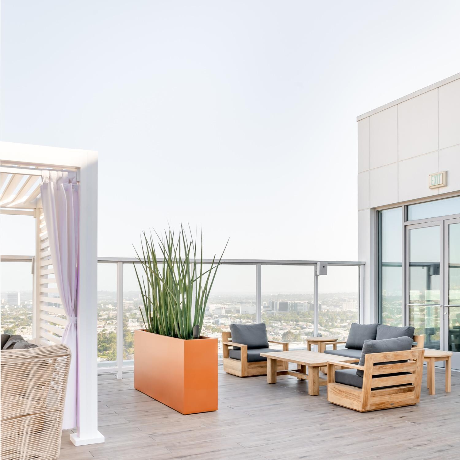 Teak + Table Atlantic Teak Patio Club Chair in Carbon - Rooftop Seating - Lifestyle thumbnail