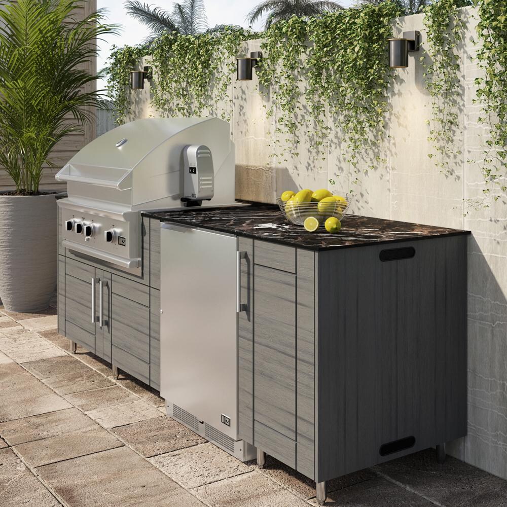 WeatherStrong Bimini 7 1/2 Ft Outdoor Kitchen Island w/ DCS Natural Gas Grill & Refrigerator in Dark Ash/Midnight Ice - On Patio - Lifestyle thumbnail