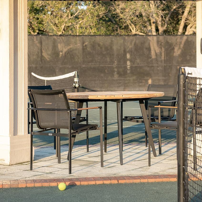 Teak + Table St Barts Aluminum Stacking Dining Chair in White - Tennis Court - Lifestyle thumbnail