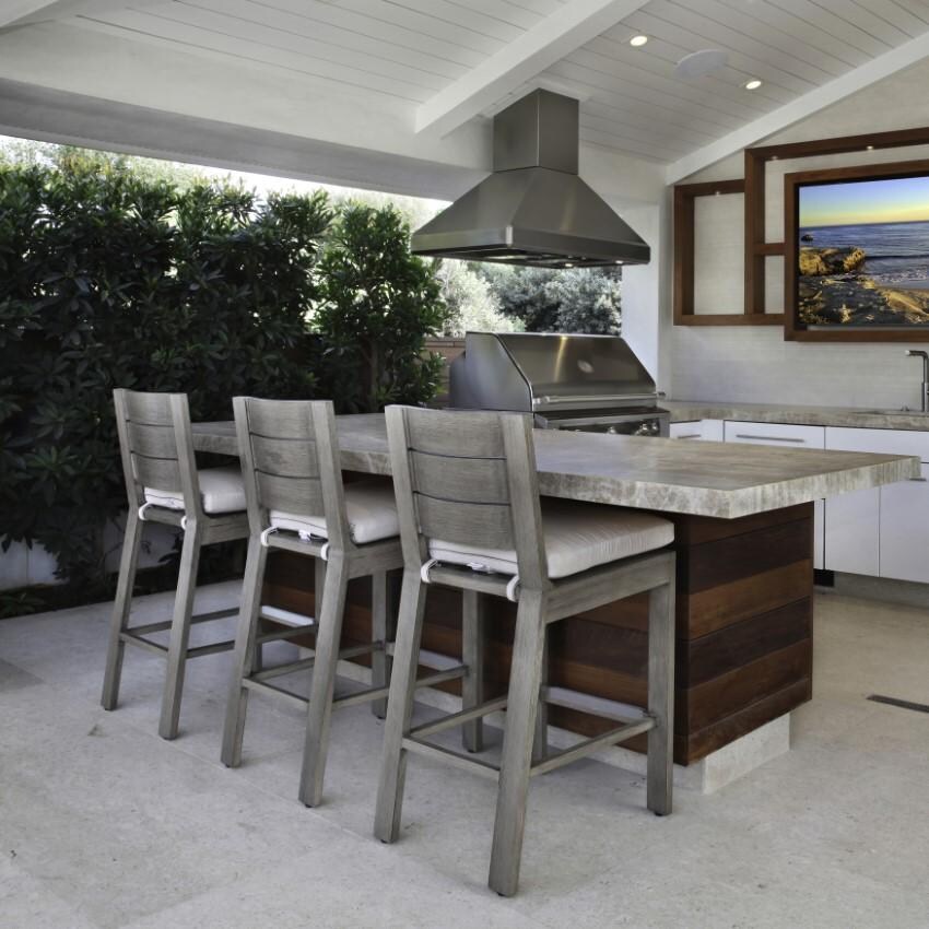 Laguna Aluminum Counter Stool w/ No Welt in Driftwood/Spectrum Indigo by Sunset West - Shown by Counter - Lifestyle thumbnail