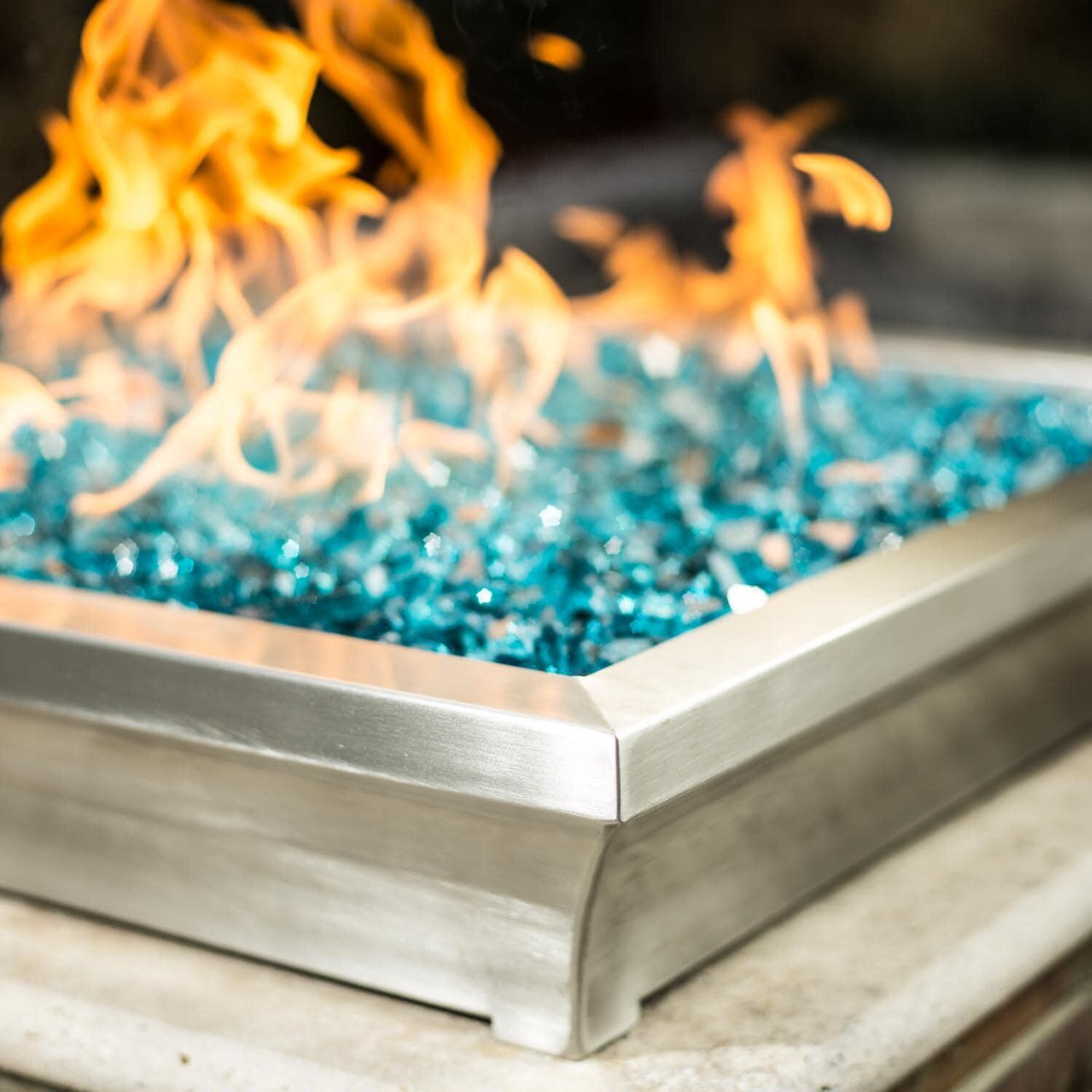 BBQGuys Signature ALP-FBL-LAV-SS-24-L Lavelle 24-Inch Square Low-Rise Natural Gas Column Fire Bowl - Stainless Steel - Side - Shown with 1/2 Inch Caribbean Blue Reflective Fire Glass thumbnail