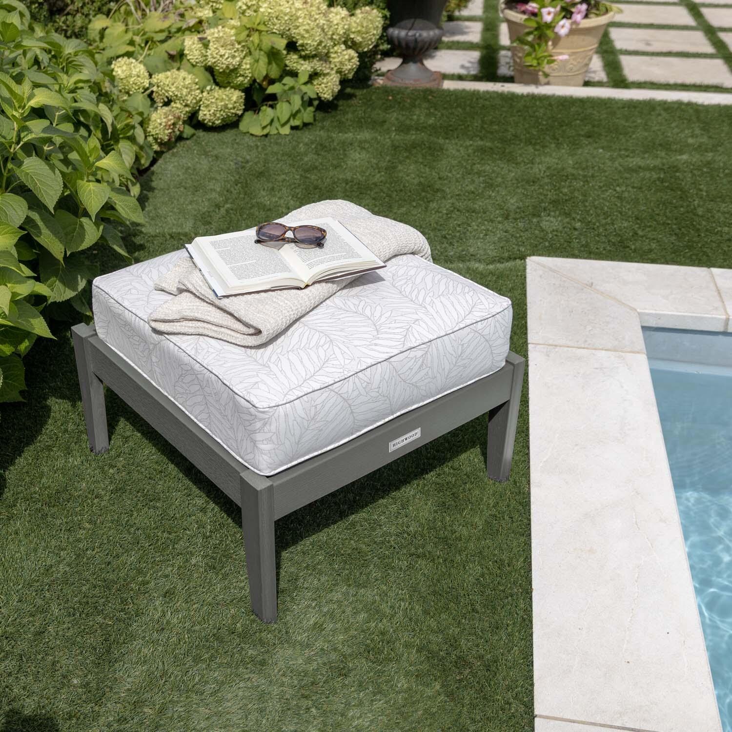 Blushing Bay Recycled Plastic Ottoman in Lively Parchment/Coastal Teak by Lakeview Outdoor Designs - By Pool Close Up - Lifestyle thumbnail