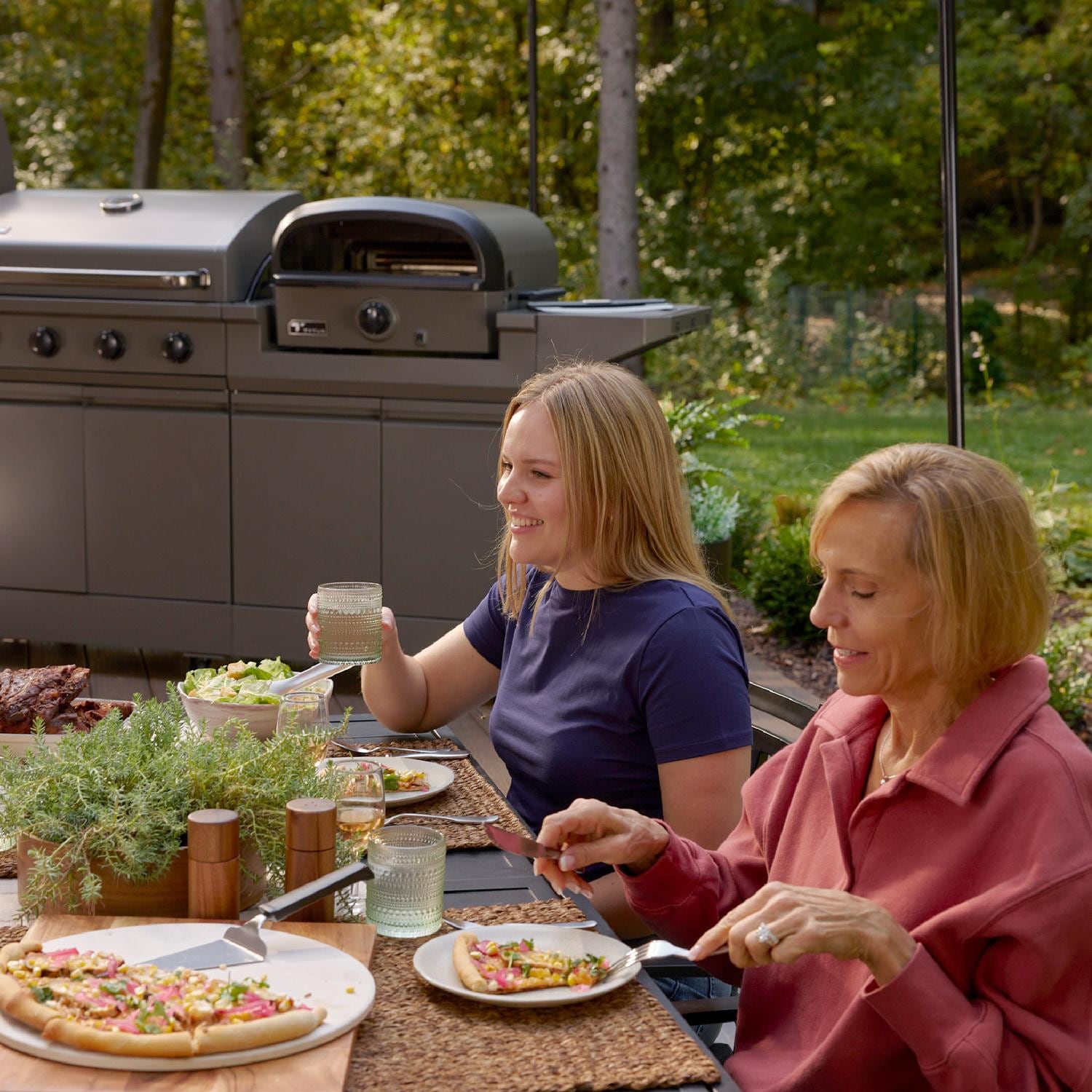 TYTUS TDT-BUN-053 Modular Duo w/ 4-Burner Gas Grill & Gas Pizza Oven - Cooking on Patio - Lifestyle thumbnail