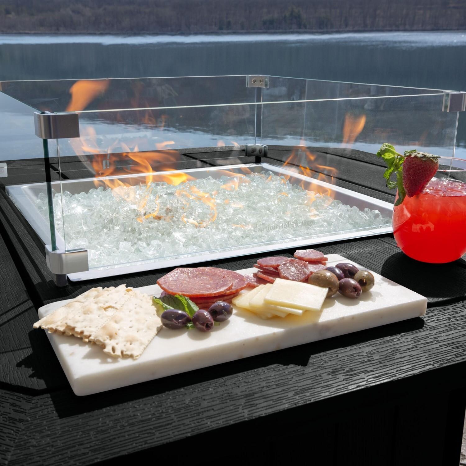 Harborview Octagonal Fire Pit Table in Black by Lakeview Outdoor Designs - In Use - Charcuterie Board - Lifestyle thumbnail