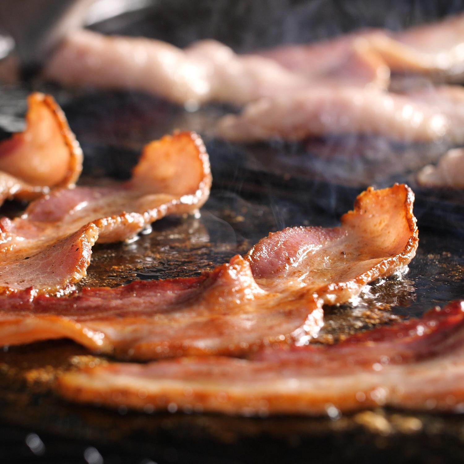 Everdure HBG2PLATE Flat Plate For FORCE 48-Inch Propane Grill - Cooking Bacon - Close Up thumbnail