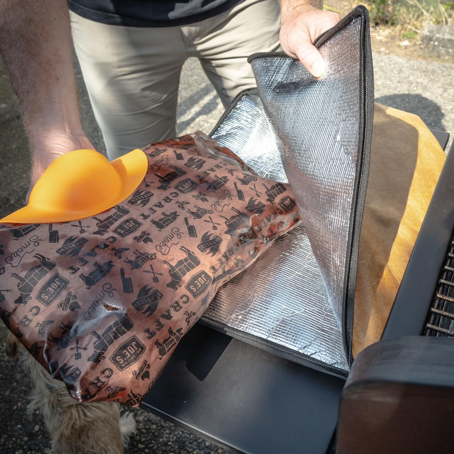 Drip EZ V2 Pork Master Bundle - Orange - Inserting Wrapped Cooked Food in BBQ Blanket - Lifestyle thumbnail