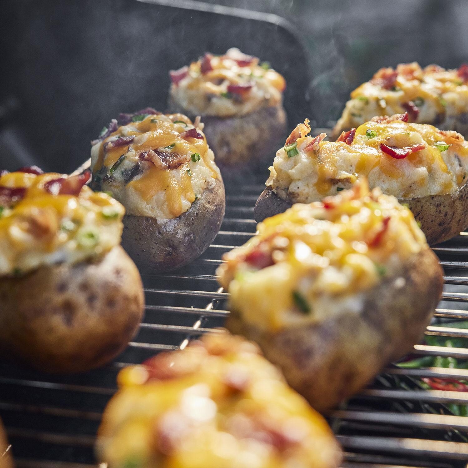 Weber 1500120 Searwood 600 Porcelain Coated Steel Pellet Grill - Baked Potatoes on Grill - Lifestyle thumbnail