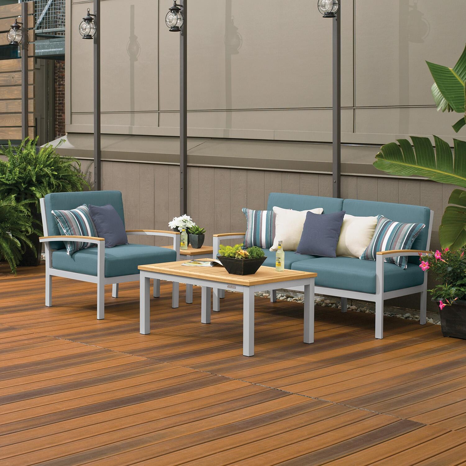 Oxford Garden 5267-PC.F Travira 4 Pc Aluminum Seating Set w/ Club Chair in Natural Tekwood/ Ice Blue by Oxford Garden - On Patio by Fireplace - Lifestyle thumbnail