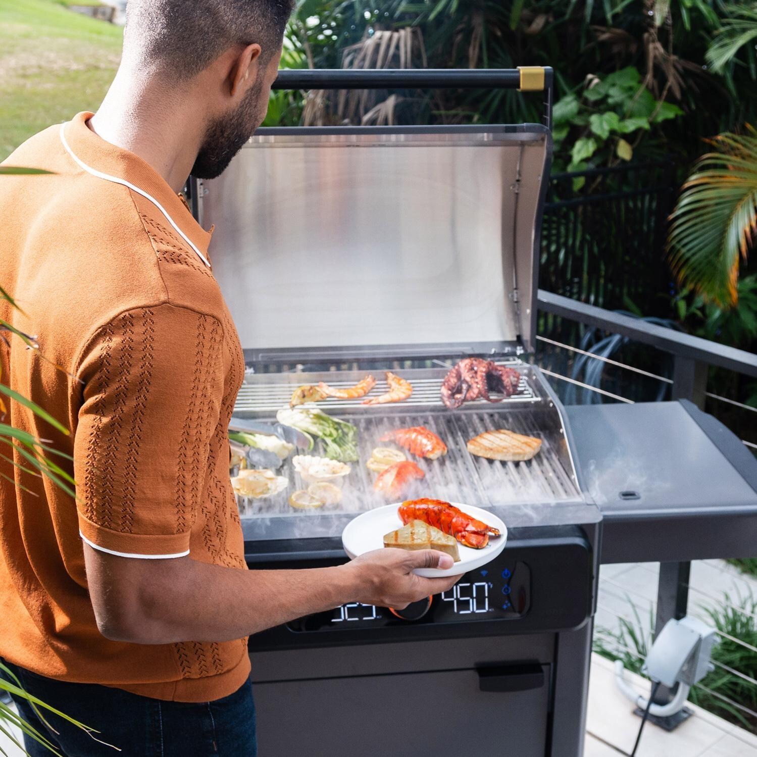 Current 24653014BC Model G Dual Zone Electric Grill W/ Cabinet in Black - Cooking Front View - Lifestyle thumbnail