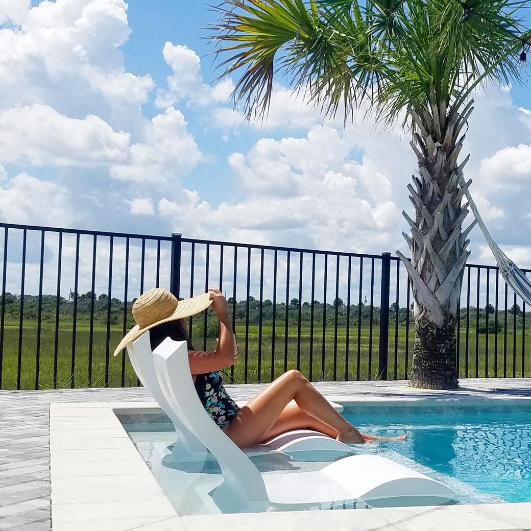 Ledge Lounger Signature In Pool Chair - Sandstone - Shown in White - Lifestyle thumbnail