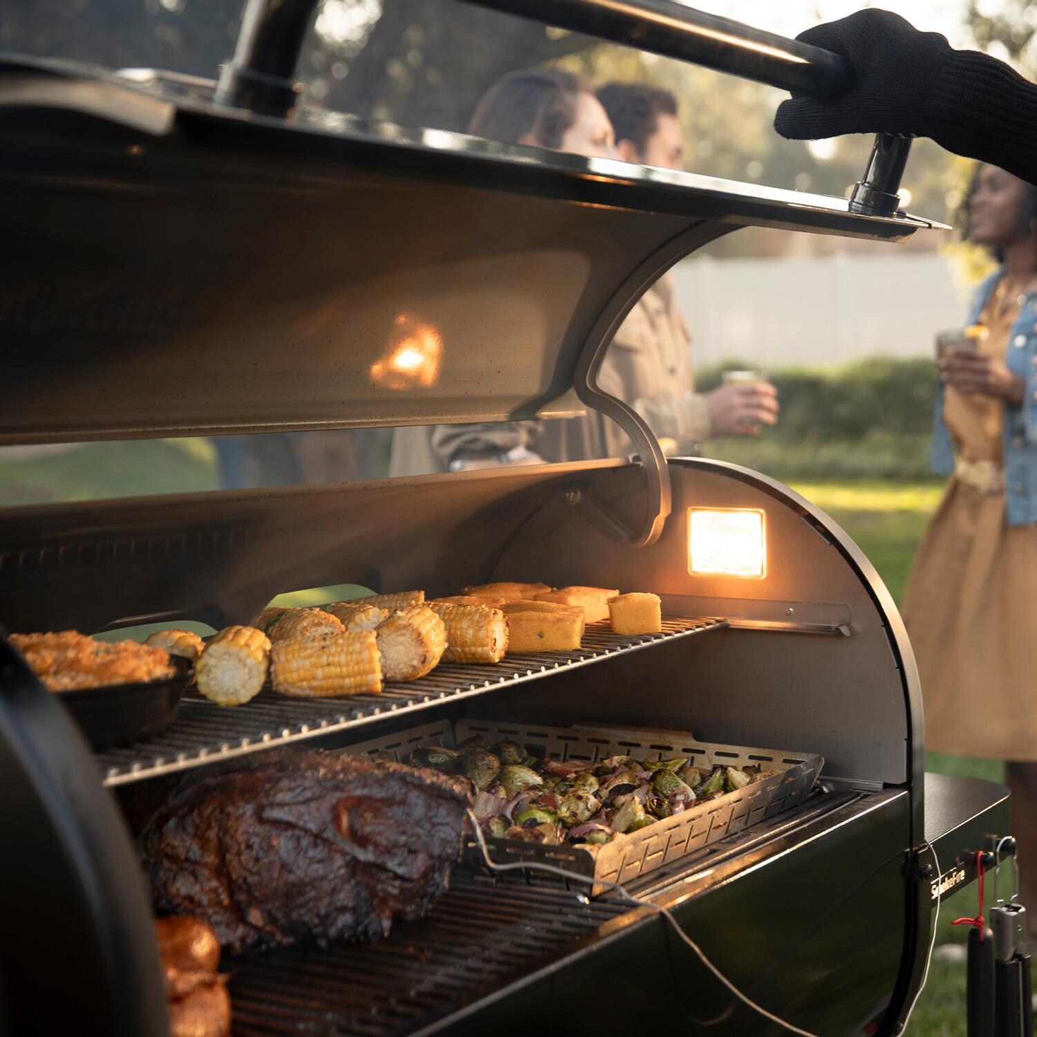 Weber 23611501 SmokeFire EPX6 STEALTH Edition 36-Inch Wi-Fi Enabled Wood Fired Pellet Grill - Lifestyle View thumbnail