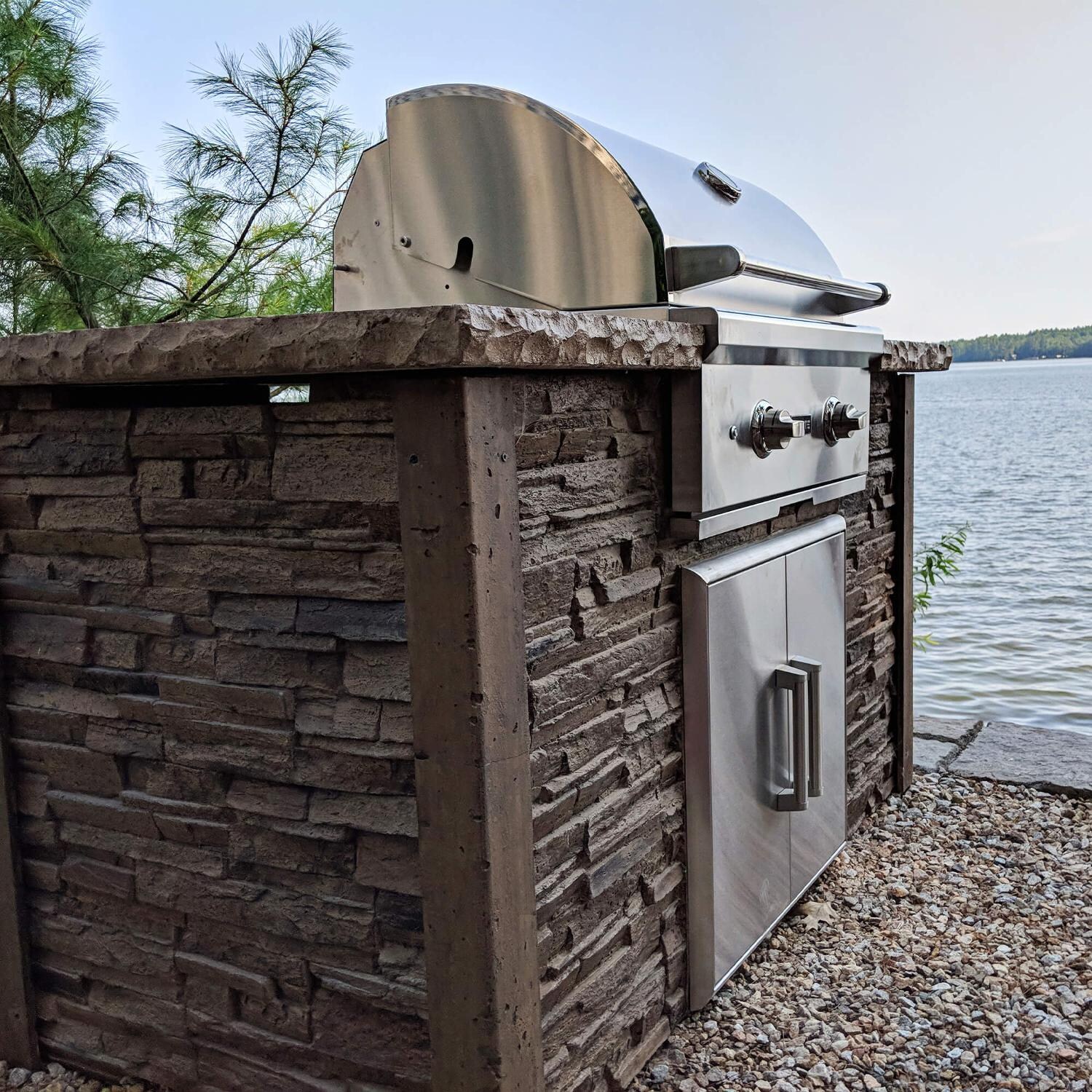 Coyote RTAC-G5-SB-C1C28NG Ready-To-Assemble 5 Ft Outdoor Kitchen Island With 28-Inch C-Series Natural Gas Grill - Stacked Stone/Brown Terra - Lifestyle View Left Side thumbnail