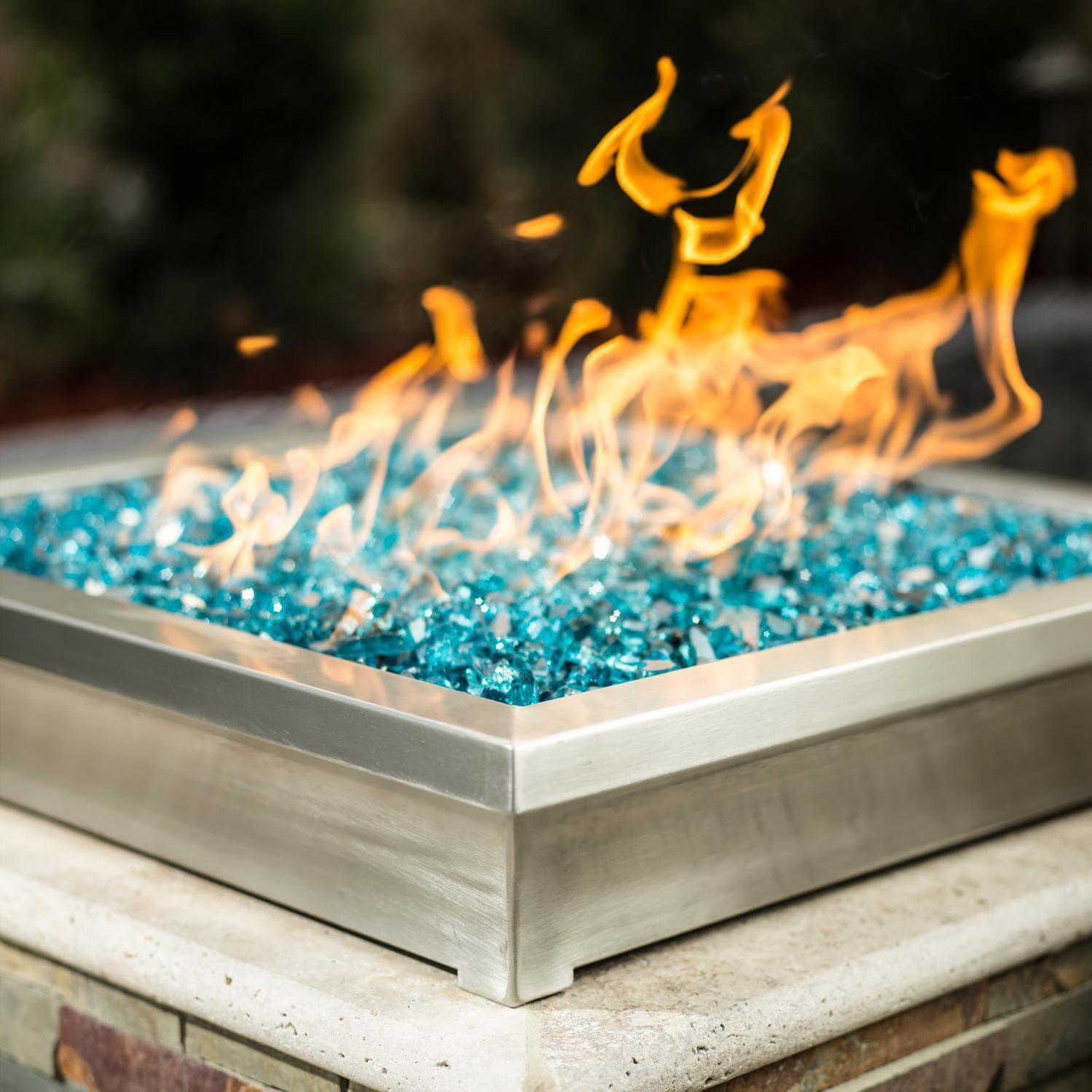 BBQGuys Signature ALP-FBL-LAV-SS-24-L Lavelle 24-Inch Square Low-Rise Natural Gas Column Fire Bowl - Stainless Steel - Angled - Shown with 1/2 Inch Caribbean Blue Reflective Fire Glass thumbnail