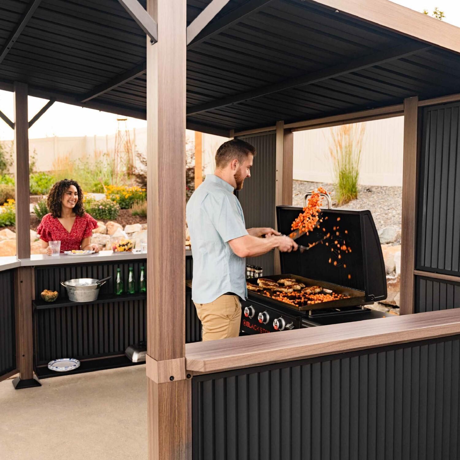 Blackstone 10 x 10-Foot Bar and Griddle/Grill Pavilion - Tossing Food - Lifestyle thumbnail