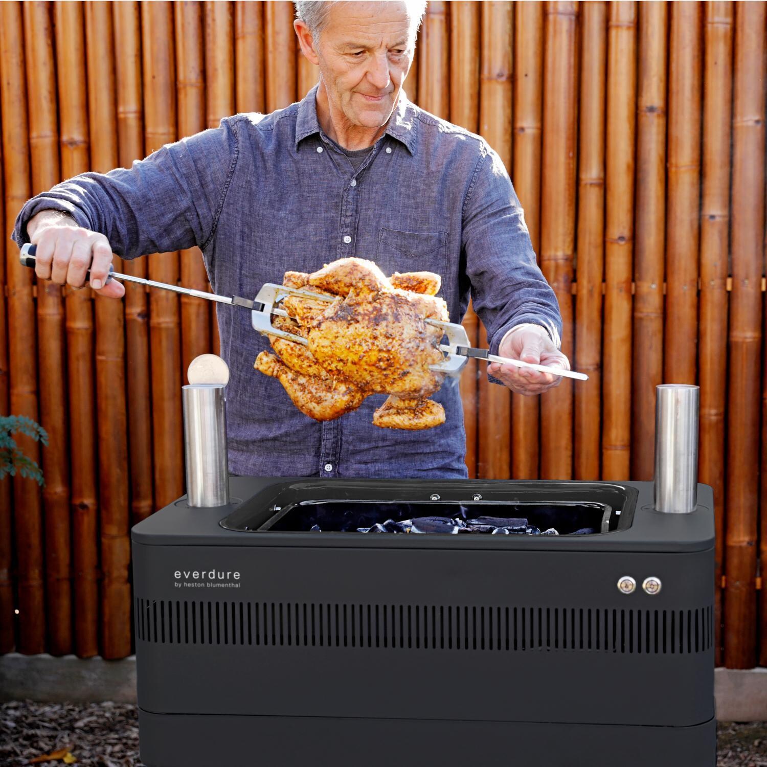 Everdure HBCE1BBSUS FUSION 29-Inch Charcoal Grill w/ Rotisserie & Electronic Ignition - Matte Black - Setting up Rotisserie - Lifestyle thumbnail