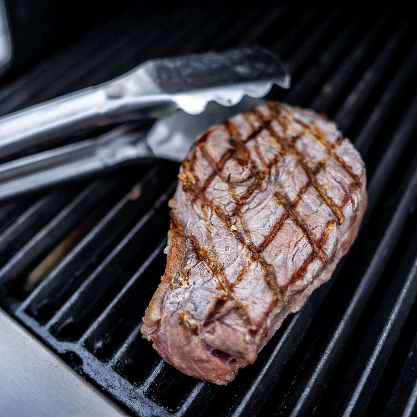 Broil King Stainless Steel Imperial Tongs - 64112 - Grabbing Steak Up Close - Detail thumbnail