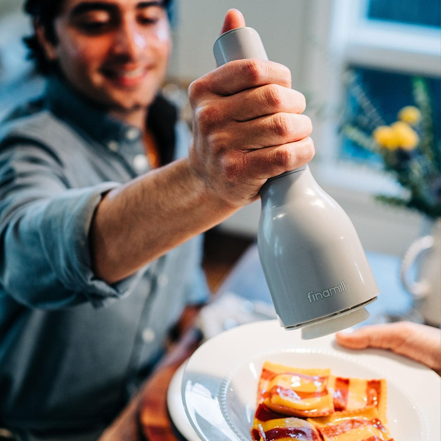 FinaMill GP803437-111STO Classic Battery Spice Grinder in Stone w/ 1 Everyday Pod & 1 Peppercorn Pod - In Use - Lifestyle thumbnail