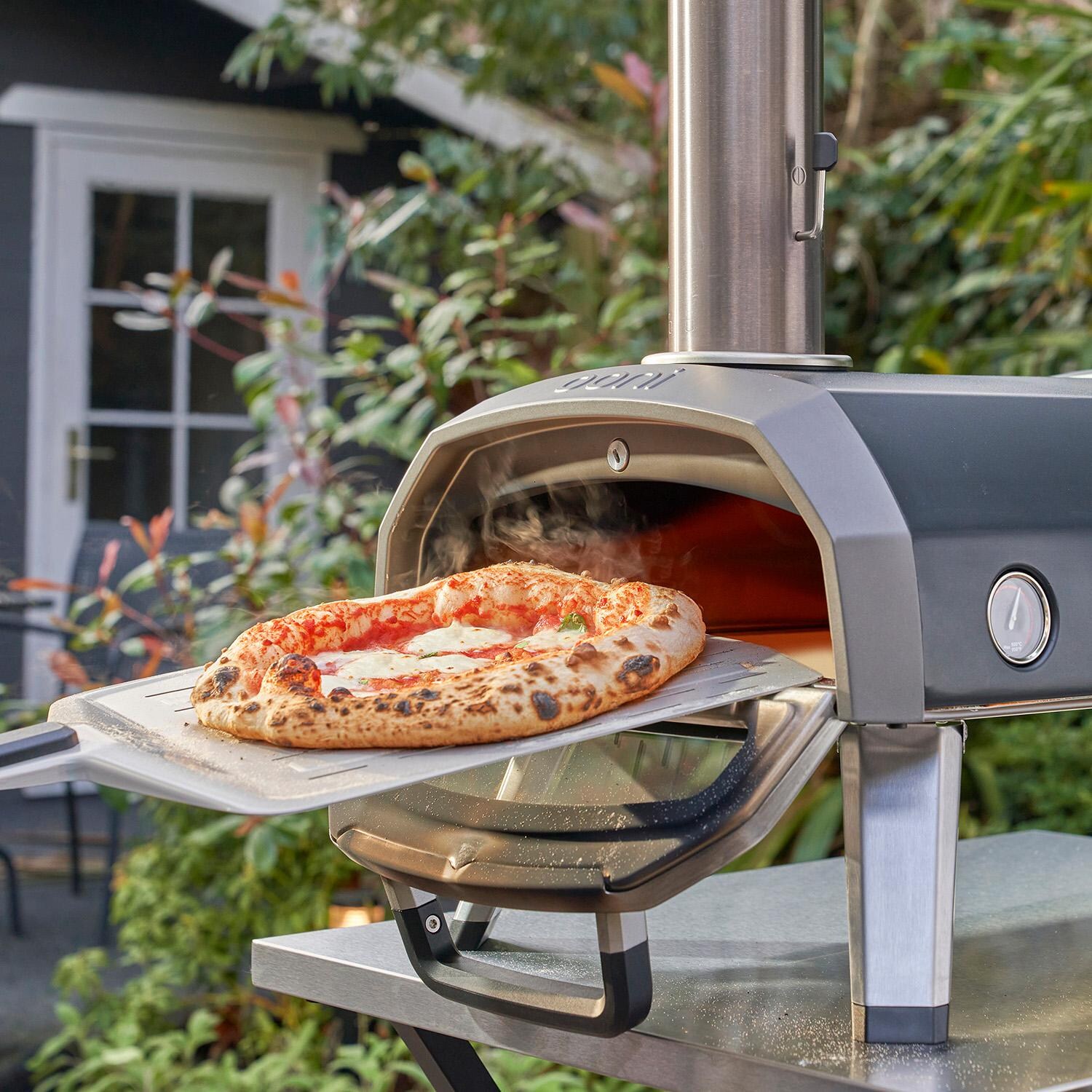 Ooni UU-P25100 Karu 12G Multi-Fuel Portable Pizza Oven - Retrieving Pizza thumbnail