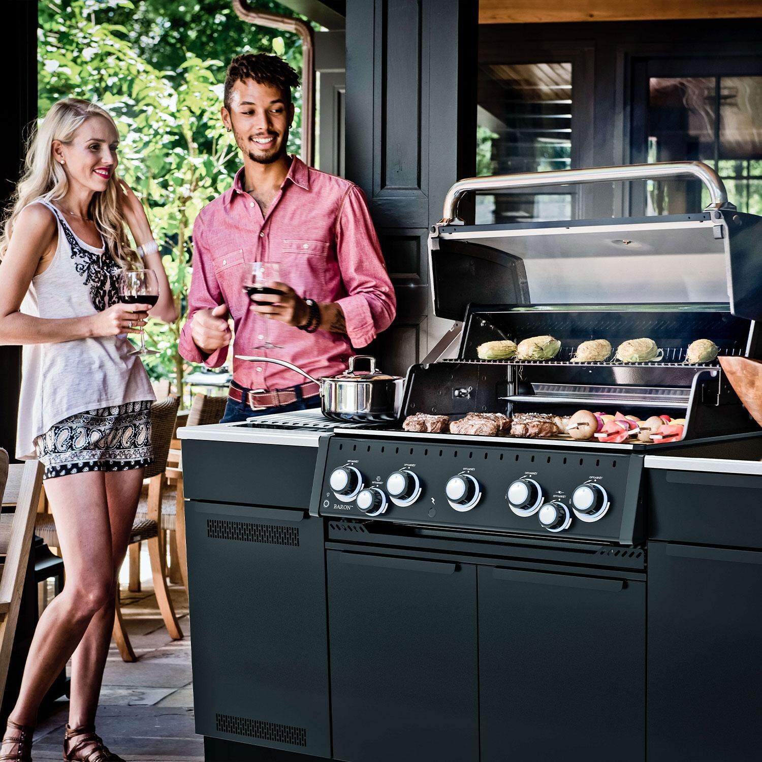 Broil King 876847 Baron 590i Shadow 5 Burner Natural Gas Grill Center w/ Rotisserie & Side Burner - Grilling Food & Warming Sauce on Side Burner w/ Friends - Lifesyle thumbnail