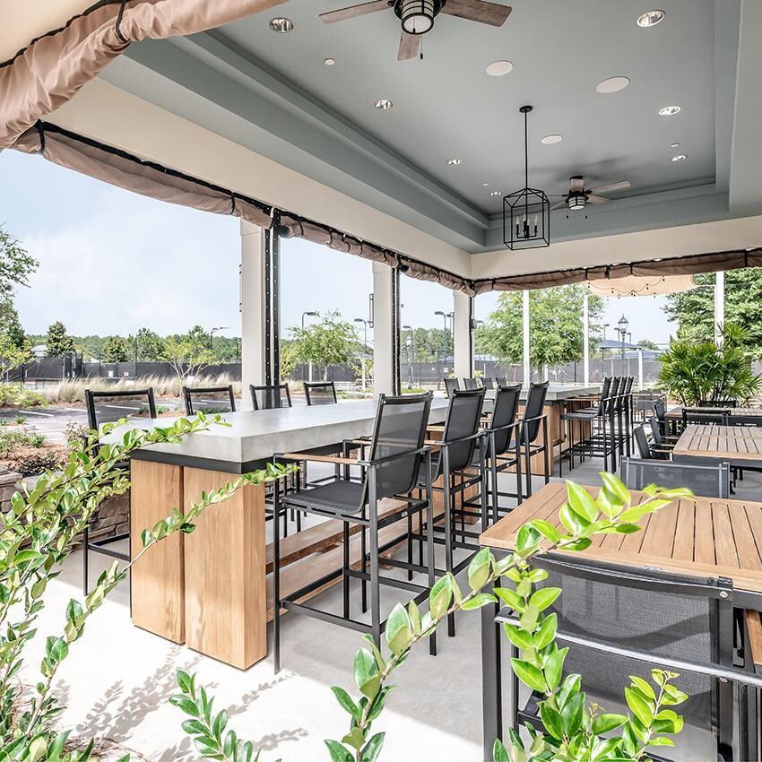 Teak + Table St Barts Aluminum Bar Chair in White - Outside at Table - Lifestyle thumbnail