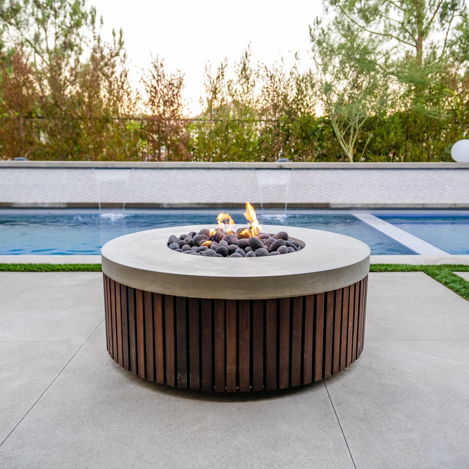 Prism Hardscapes SCPH-484-5LP Hampton 48-in Round Propane Gas Fire Pit - By the Pool (Shown in Natural) - Lifestyle thumbnail