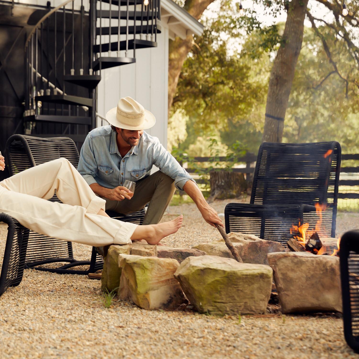 Teak + Table Breeze Olefin Rope Patio Armless Club Chair in Charcoal - Tending the Fire - Lifestyle thumbnail