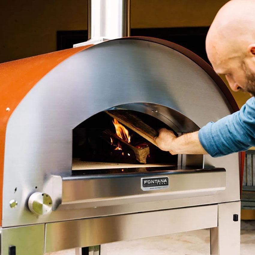 Fontana Forni FTROM-H-A Roma Hybrid Pizza Oven - Anthracite - On Portable Cart Tending Fire (Optional) - Lifestyle thumbnail