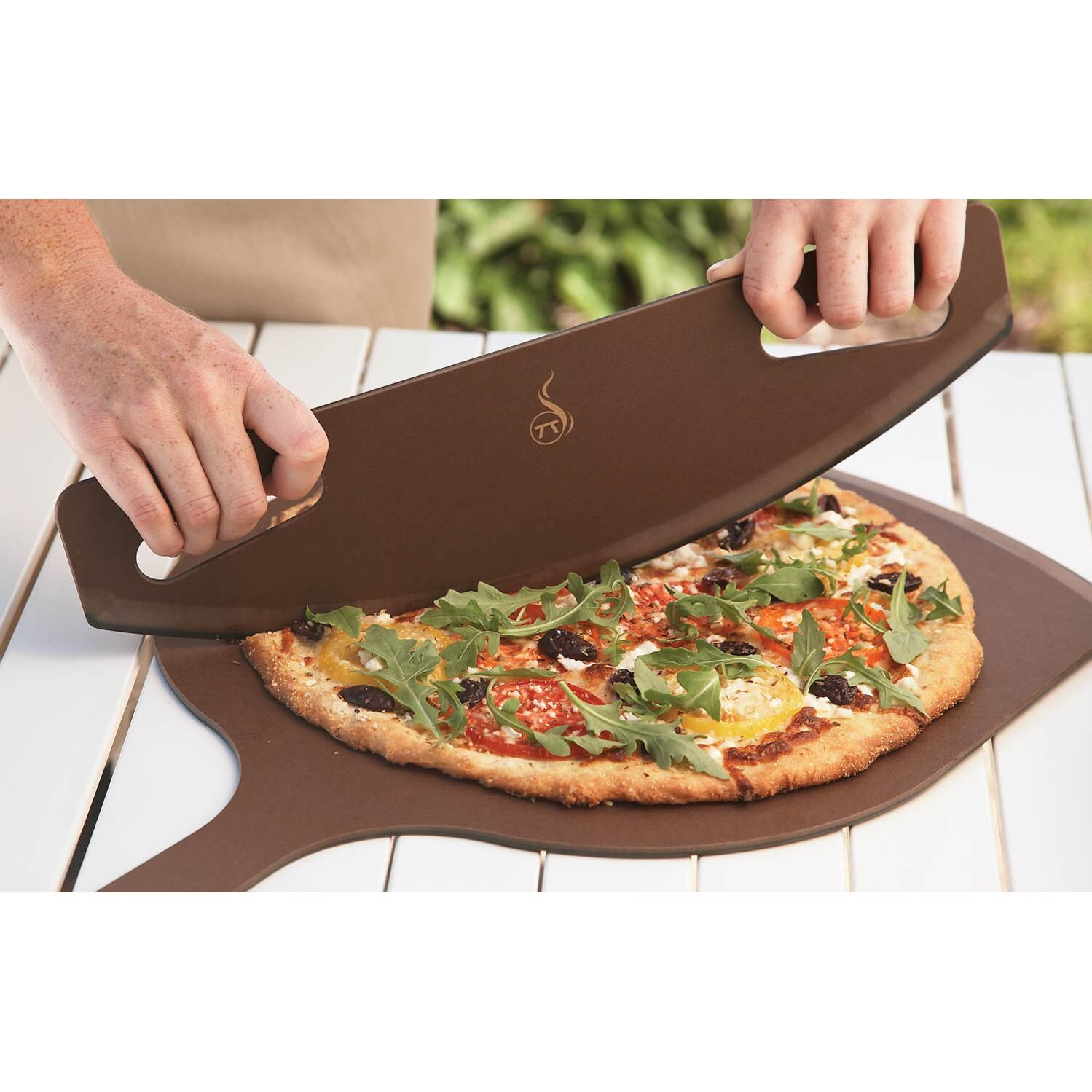 Phenolic Paper Rocking Pizza Cutter - Shown In Use With Pizza Peel (Not Included) thumbnail