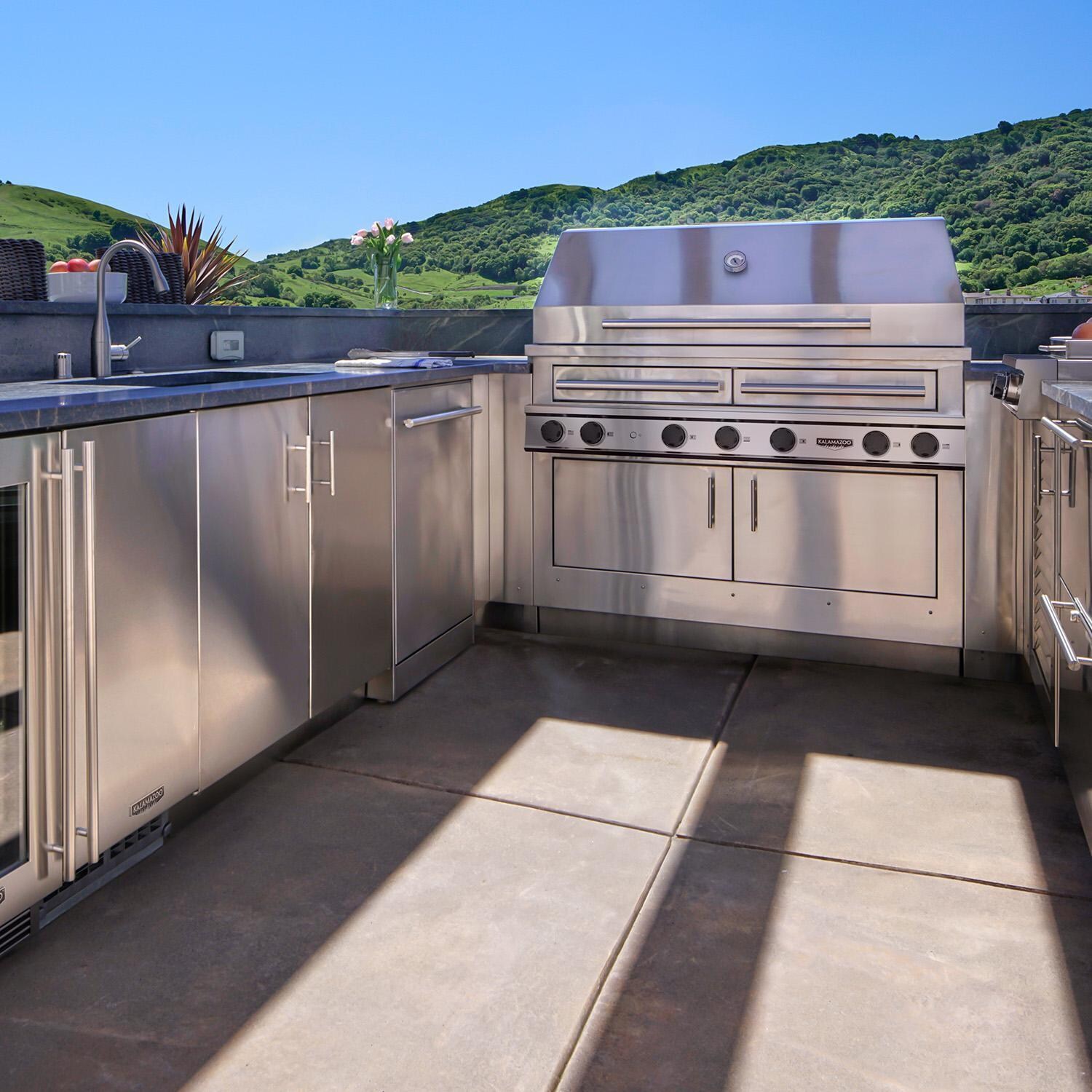 Kalamazoo K1000HB Hybrid Fire Four Burner Marine Grade Built-In Natural Gas Grill W/ Meat, Vegetable, & Two Plancha Grill Surface Grates - Shown in Outdoor Kitchen - Lifestyle thumbnail