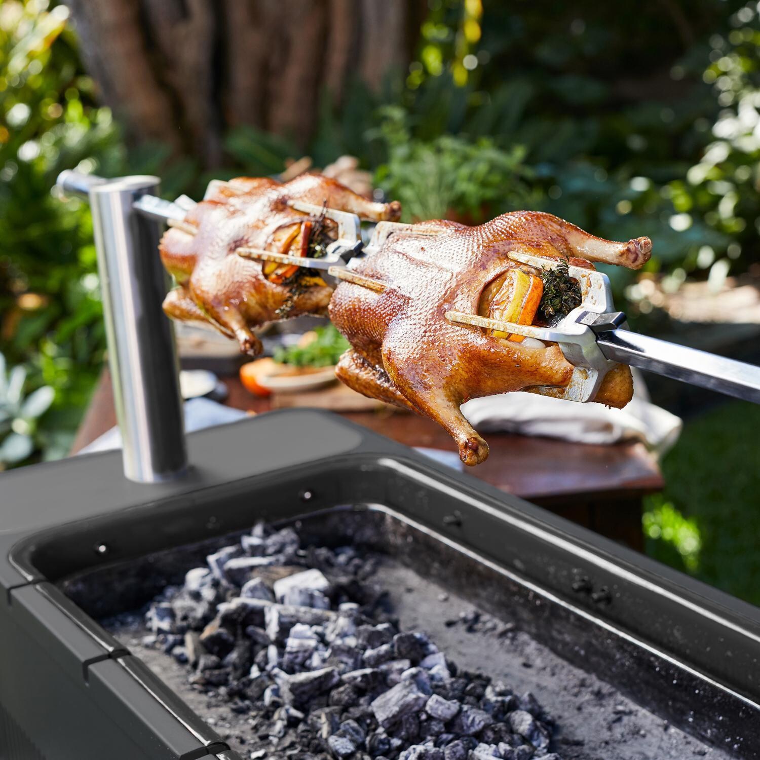 Everdure HBCE1BBSUS FUSION 29-Inch Charcoal Grill w/ Rotisserie & Electronic Ignition - Matte Black - Roasting 2 Chicken on Rotisserie - Lifestyle thumbnail