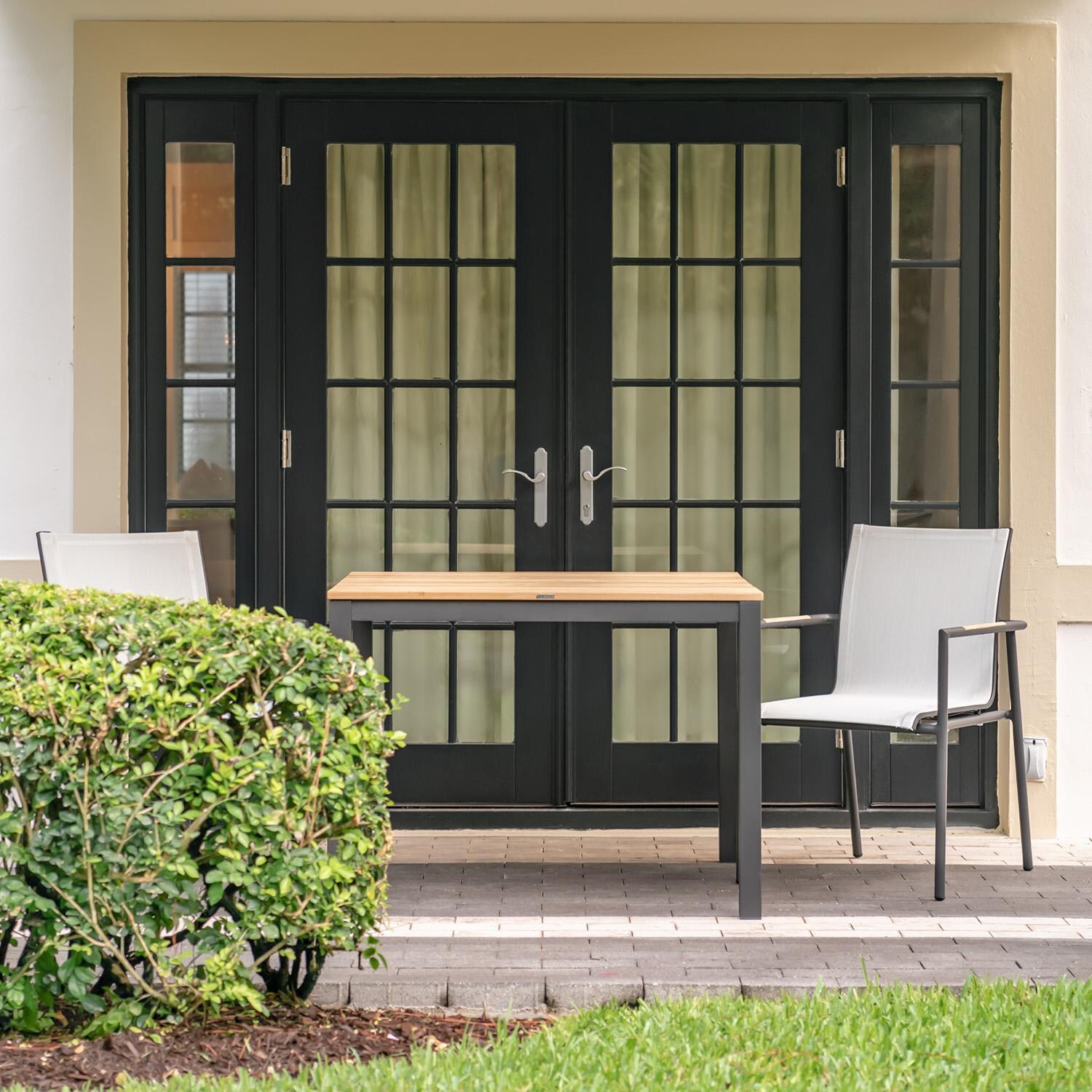 Teak + Table Paros Stacking Dining Chair in Asteroid/White - Under Balcony - Lifestyle thumbnail