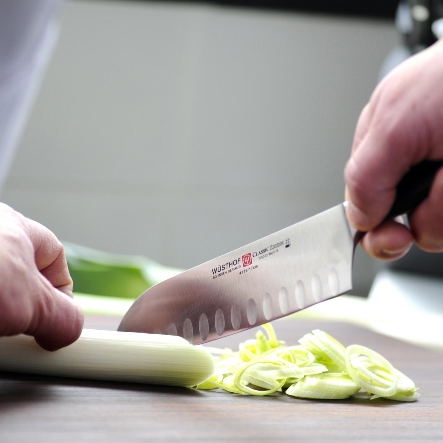 Wusthof Classic Ikon 7-Inch Hollow Edge Santuko Knife - In Use thumbnail