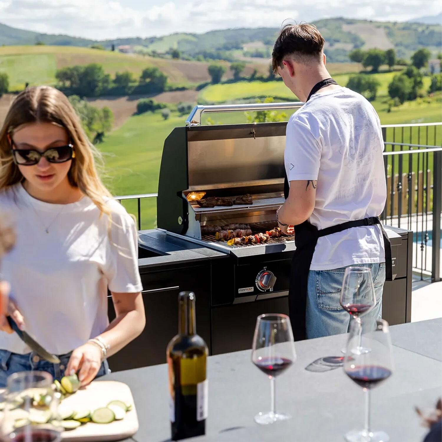 Fontana Forni Lynx Grill Cabinet W/ Iron Frost Countertop & End Panel - Cooking on Grill Attached to Cabinet - Lifestyle thumbnail