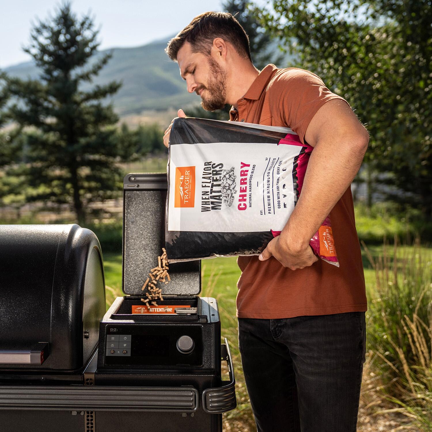 Traeger 20 Lb. Natural Hardwood Pellets - Cherry - Pouring - Lifestyle thumbnail