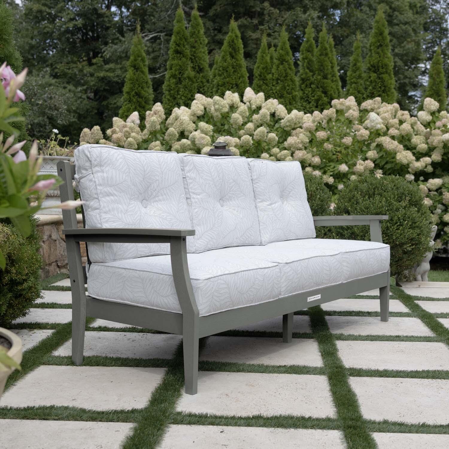 Blushing Bay 3 Person Recycled Plastic Sofa in Lively Parchment/Coastal Teak by Lakeview Outdoor Designs - Side View - Lifestyle thumbnail