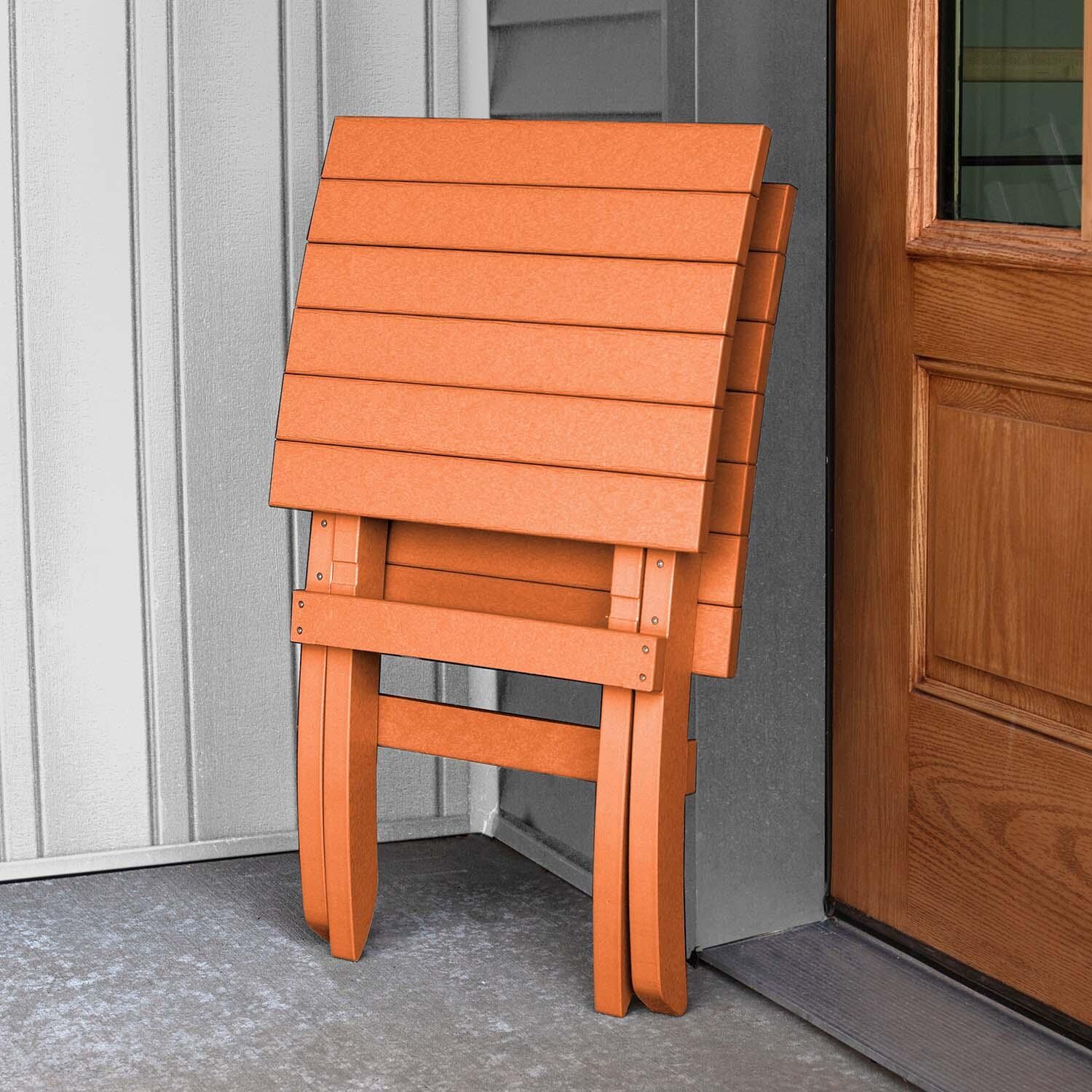Hazel Cove Recycled Plastic Folding & Stacking Dining Side Chair in Citrus Orange by Lakeview Outdoor Designs - Folded - Lifestyle thumbnail