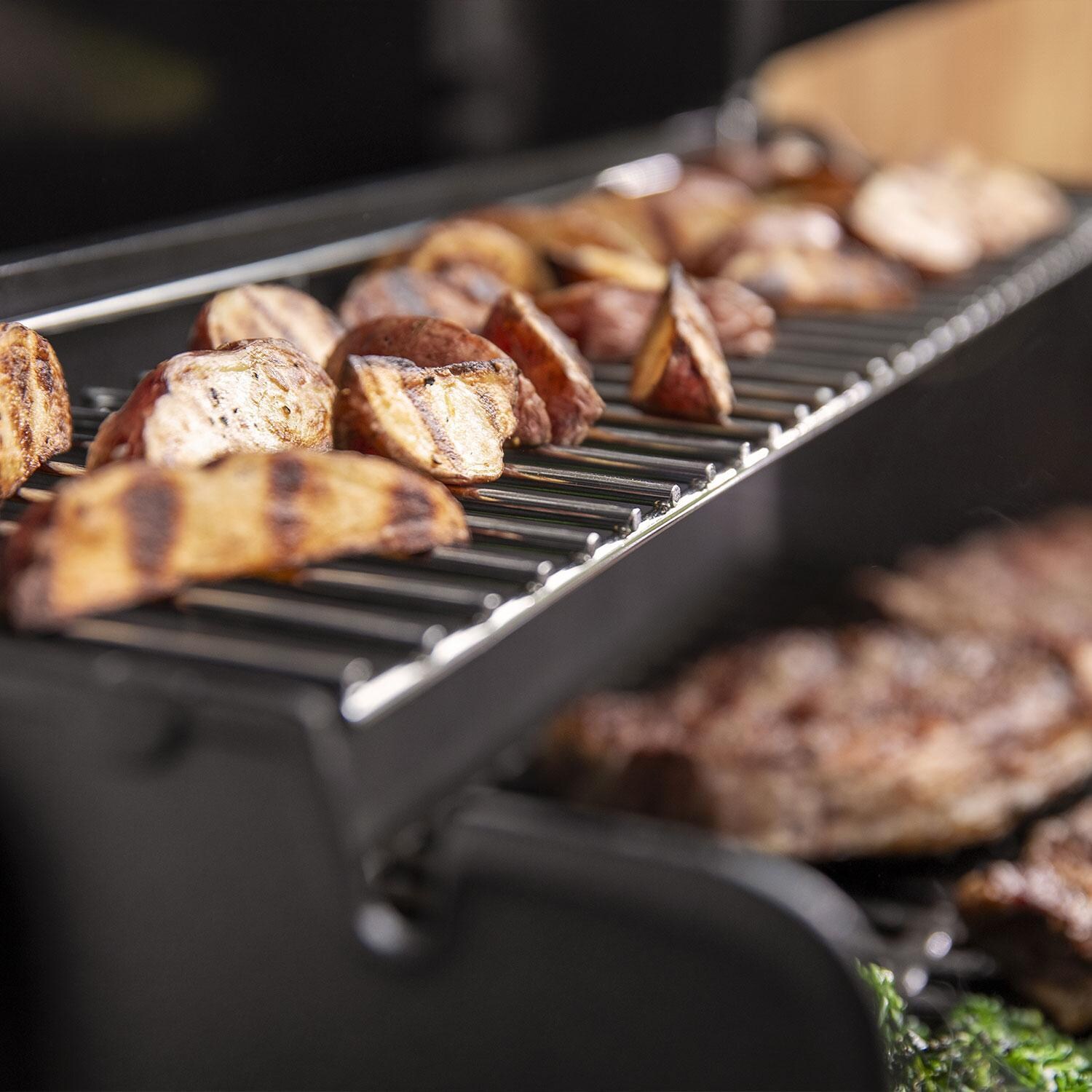 Weber GENESIS 1500011 E-315 Propane Grill - Black - Potatoes on Top Shelf - Lifestyle