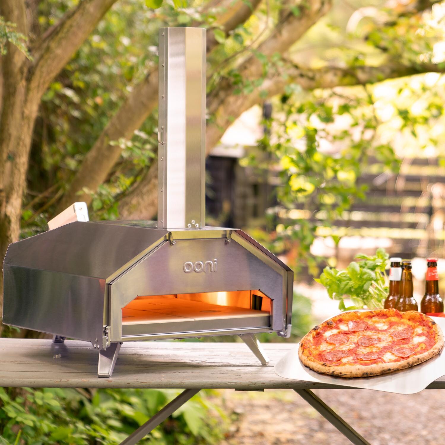Ooni Pro Stainless Steel Multi-Fuel Pizza Oven - Lifestyle View W/ Pizza Door thumbnail
