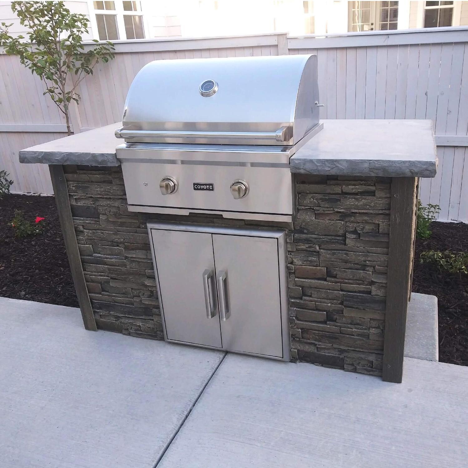 Coyote RTAC-G5-SG-C1C28LP Ready-To-Assemble 5 Ft Outdoor Kitchen Island With 28-Inch C-Series Propane Gas Grill - Stacked Stone/Stone Gray - Lifestyle View Right Angle thumbnail